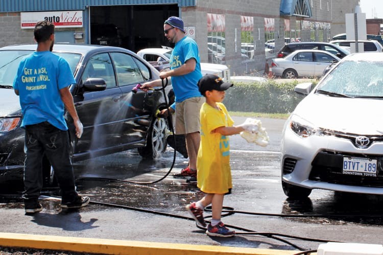 Volunteers gather at Krown’s Markham location to wash cars for the cause