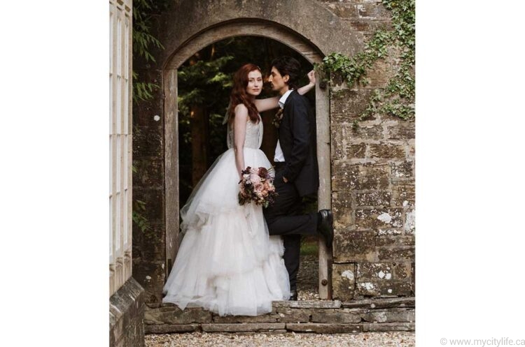 Husband and wife standing in an archway at the Florin Manor in West Wales United Kingdom