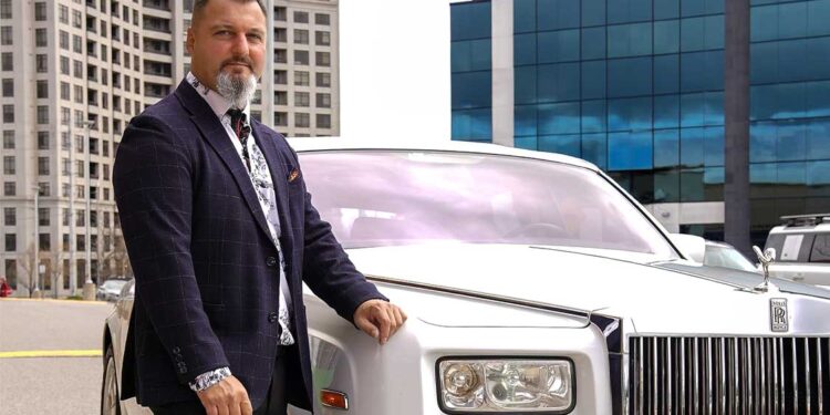 Rob Iafrate of A Celebrity Limousine Service standing beside a Limousine.